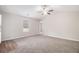 Bedroom with plush carpeting, neutral walls, and window creates a serene and inviting atmosphere, comfy at 100 Hunters Keep Trce, Covington, GA 30014