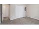 A carpeted bedroom features a bi-fold closet and an additional door to another room at 100 Hunters Keep Trce, Covington, GA 30014