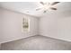 Bright, carpeted bedroom with a ceiling fan and natural light from a window at 100 Hunters Keep Trce, Covington, GA 30014