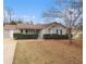 Charming single-story home featuring a well-maintained lawn and blossoming tree, perfect for curb appeal at 100 Hunters Keep Trce, Covington, GA 30014