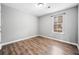 Bedroom with laminate floors, fresh gray paint, natural light from window and simple decor at 1389 Ling Dr, Austell, GA 30168