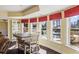 Bright dining area with natural light, pool views, and comfortable seating at 6980 Polo Fields Pkwy, Cumming, GA 30040