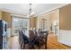 Elegant dining room with a wooden table, chairs, and hardwood floors at 6980 Polo Fields Pkwy, Cumming, GA 30040