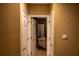 Hallway to a bedroom with white doors, neutral walls, and a glimpse of comfortable bedding at 1159 Bowerie Chase, Powder Springs, GA 30127