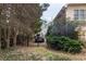 View of a driveway through trees, with a red truck parked behind a wrought-iron fence at 1159 Bowerie Chase, Powder Springs, GA 30127