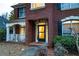 Inviting brick home featuring a covered porch and a glass-paneled front door at 1159 Bowerie Chase, Powder Springs, GA 30127