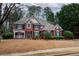 Charming two-story brick home featuring manicured landscaping and a welcoming front porch at 1159 Bowerie Chase, Powder Springs, GA 30127