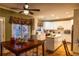 Bright kitchen featuring white cabinetry, a center island, and a large window with charming curtains at 1159 Bowerie Chase, Powder Springs, GA 30127