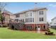 Back exterior showcasing a deck and patio with a large grassy area perfect for outdoor entertaining at 1900 Sanborne Way, Dacula, GA 30019