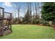 Expansive backyard featuring lush green lawn and mature trees providing ample shade and privacy at 1900 Sanborne Way, Dacula, GA 30019