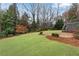 Beautifully landscaped backyard with a well-maintained lawn and a stone patio area, ideal for outdoor relaxation at 1900 Sanborne Way, Dacula, GA 30019