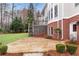 Stone patio with a backyard view of the multi-level deck and well-manicured lawn at 1900 Sanborne Way, Dacula, GA 30019