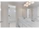 Bright bathroom featuring double sink vanity with white cabinets and full tub at 1900 Sanborne Way, Dacula, GA 30019