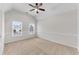 Spacious bedroom with neutral carpet, ceiling fan, two windows, and a vaulted ceiling at 1900 Sanborne Way, Dacula, GA 30019