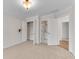 Bedroom with neutral carpet, closet, modern lighting, and doorway to bathroom at 1900 Sanborne Way, Dacula, GA 30019