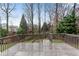 View of the exterior deck overlooking the wooded backyard and green lawn at 1900 Sanborne Way, Dacula, GA 30019