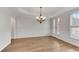 Formal dining room with hardwood floors, decorative molding, chandelier, and large windows at 1900 Sanborne Way, Dacula, GA 30019