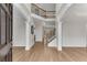 Bright foyer with hardwood floors, staircase, and open floor plan featuring modern design elements at 1900 Sanborne Way, Dacula, GA 30019