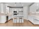 Well-lit kitchen featuring white cabinets, quartz countertops, and stainless appliances at 1900 Sanborne Way, Dacula, GA 30019