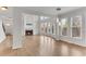 Open-concept living room with a fireplace, built-in shelving, and large windows at 1900 Sanborne Way, Dacula, GA 30019