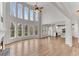 Bright and airy living room featuring large windows, fireplace, and hardwood floors at 1900 Sanborne Way, Dacula, GA 30019