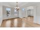 Elegant living room with large windows, hardwood floors, decorative molding, and open entrance at 1900 Sanborne Way, Dacula, GA 30019