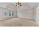 Large main bedroom with tray ceiling, ceiling fan, and natural light at 1900 Sanborne Way, Dacula, GA 30019