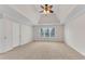 Bright main bedroom featuring plush carpet and tray ceiling with ceiling fan at 1900 Sanborne Way, Dacula, GA 30019