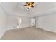 Neutral main bedroom with plush carpet, tray ceiling and adjoining bathroom at 1900 Sanborne Way, Dacula, GA 30019