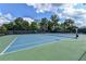 Community tennis court surrounded by trees with views of 'Hamilton Mill' at 1900 Sanborne Way, Dacula, GA 30019