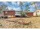 View of a large backyard featuring a brick wall and the back of the brick home at 2458 Kelly Lake Dr, Decatur, GA 30032