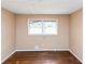 Bright bedroom featuring hardwood floors, a window, and neutral wall color at 2458 Kelly Lake Dr, Decatur, GA 30032