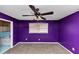 Bedroom features purple walls, a ceiling fan, and a window at 2458 Kelly Lake Dr, Decatur, GA 30032