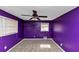 Bedroom features purple walls, carpet, a ceiling fan, and windows at 2458 Kelly Lake Dr, Decatur, GA 30032