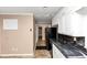 Galley-style kitchen with beige walls, black marble countertops, and an adjacent eat-in area at 2458 Kelly Lake Dr, Decatur, GA 30032