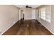 Spacious living room with pristine hardwood floors, natural light from large windows, and a ceiling fan at 2458 Kelly Lake Dr, Decatur, GA 30032