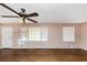 Bright living room featuring hardwood floors, a ceiling fan, and ample natural light at 2458 Kelly Lake Dr, Decatur, GA 30032