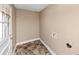 Small mud room with light beige walls and windowed white door and an installed connection for laundry machine at 2458 Kelly Lake Dr, Decatur, GA 30032