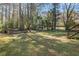 Enjoy outdoor living in this large backyard with mature trees, a hammock, and a swing set at 2781 Hollywood Dr, Decatur, GA 30033