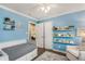 This bedroom includes a bed, chair, and shelving for books at 2781 Hollywood Dr, Decatur, GA 30033