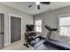 Home gym featuring ceiling fan, treadmill, TV on dresser, and grey door at 2905 Ivy Mill Drive Dr, Buford, GA 30519