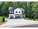 Two-story home featuring a two-car garage, a mix of board and batten and lap siding, and professional landscaping at 2905 Ivy Mill Drive Dr, Buford, GA 30519