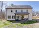 Back exterior view of two story home with a covered patio and fenced yard at 2905 Ivy Mill Drive Dr, Buford, GA 30519