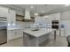 Open kitchen with stainless steel appliances, a large island, and white cabinets with wooden accents at 2905 Ivy Mill Drive Dr, Buford, GA 30519