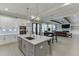 Bright open kitchen with island, pendant lights, and stainless steel appliances, seamlessly connected to living area at 2905 Ivy Mill Drive Dr, Buford, GA 30519