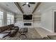 Living room featuring wood beam accents, large TV, fireplace, and open layout at 2905 Ivy Mill Drive Dr, Buford, GA 30519