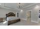 Main bedroom featuring decorative furniture, tray ceiling, and ensuite bathroom access at 2905 Ivy Mill Drive Dr, Buford, GA 30519