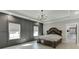 Main bedroom with decorative wall trim, tray ceiling, and walk-in closet access at 2905 Ivy Mill Drive Dr, Buford, GA 30519