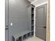 Mudroom with gray cabinets, a built-in bench, storage shelves, and gray doors at 2905 Ivy Mill Drive Dr, Buford, GA 30519