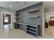 Office area with custom built-in shelves, a desk, wine cooler, and wood accents at 2905 Ivy Mill Drive Dr, Buford, GA 30519